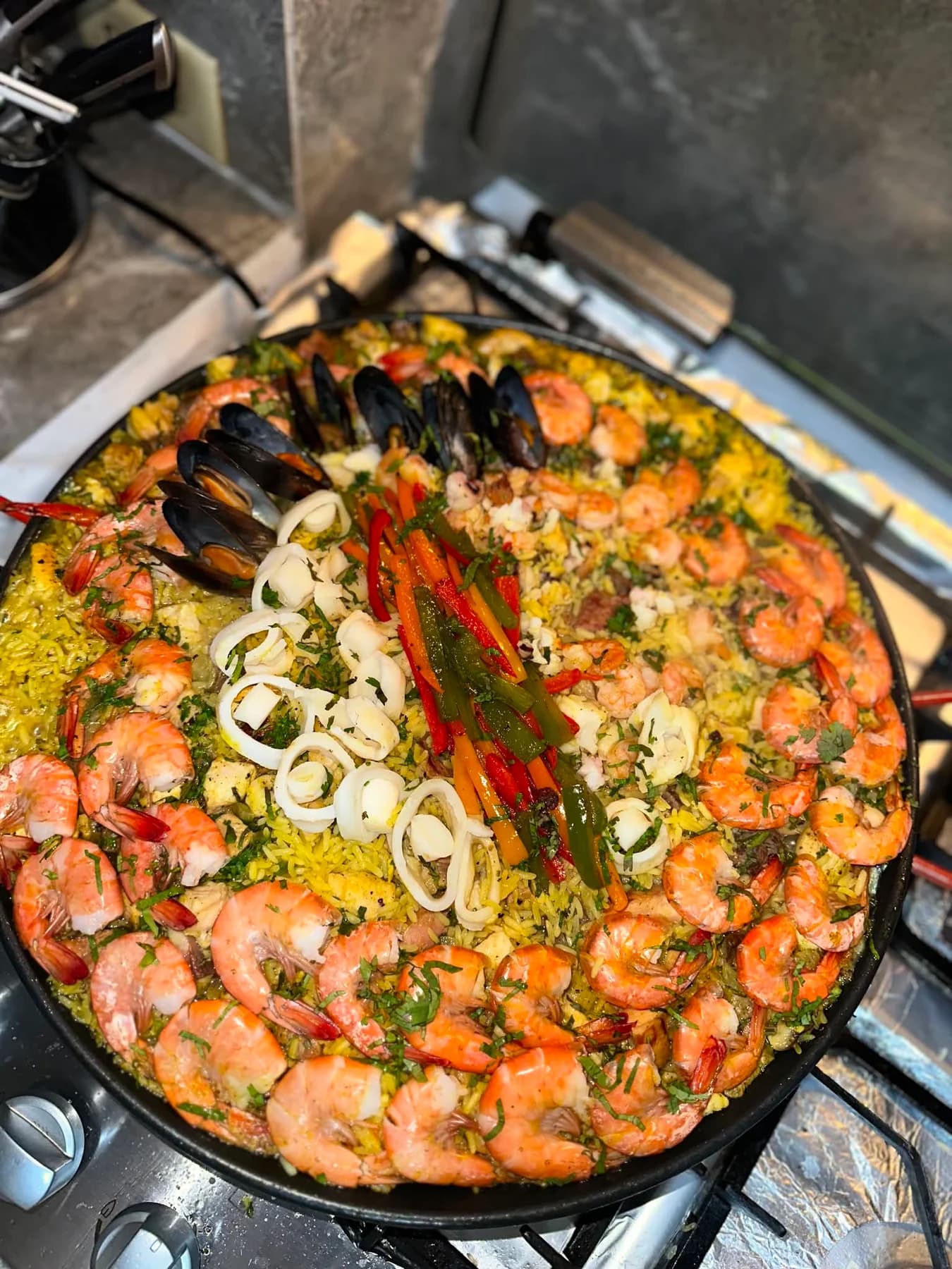 A wide seafood pan worked during Sigi's hotel training in Spain.