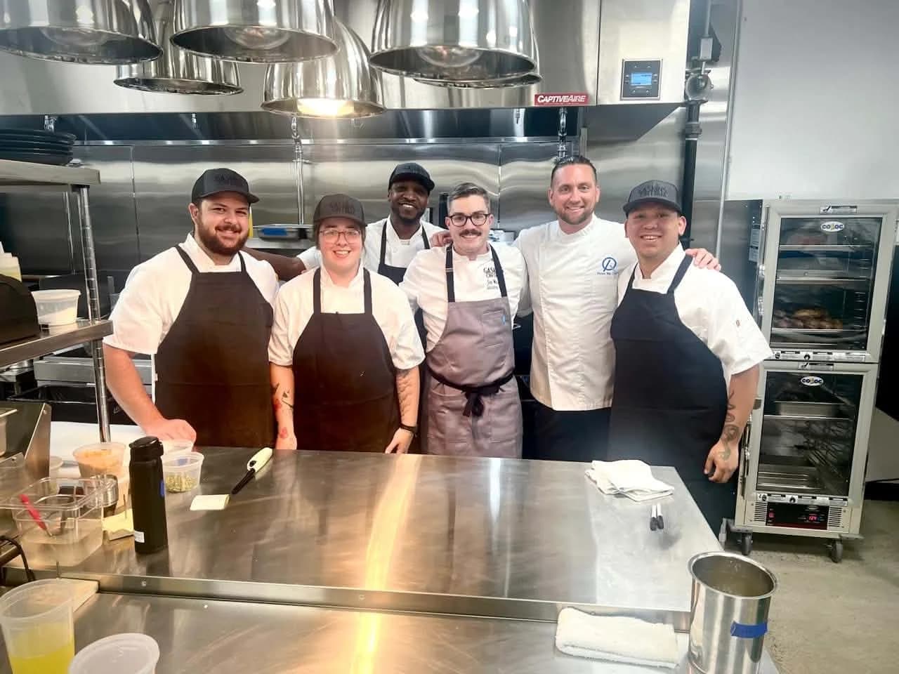 Sigi with the kitchen team at the hotel in Spain where he trained.