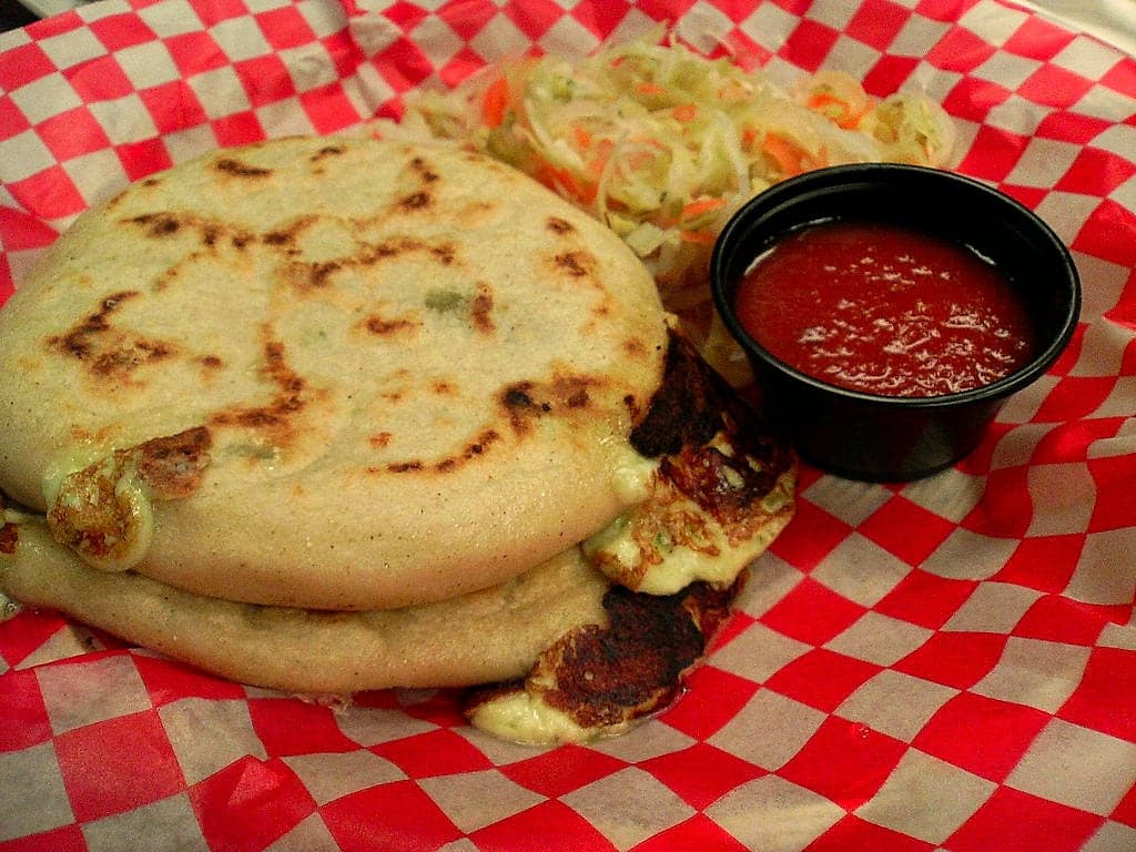Pupusas with curtido on a plate